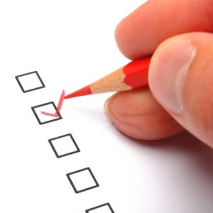Hand checking boxes in a survey questionnaire